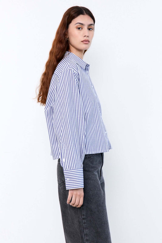 Woman wearing a blue and white striped shirt