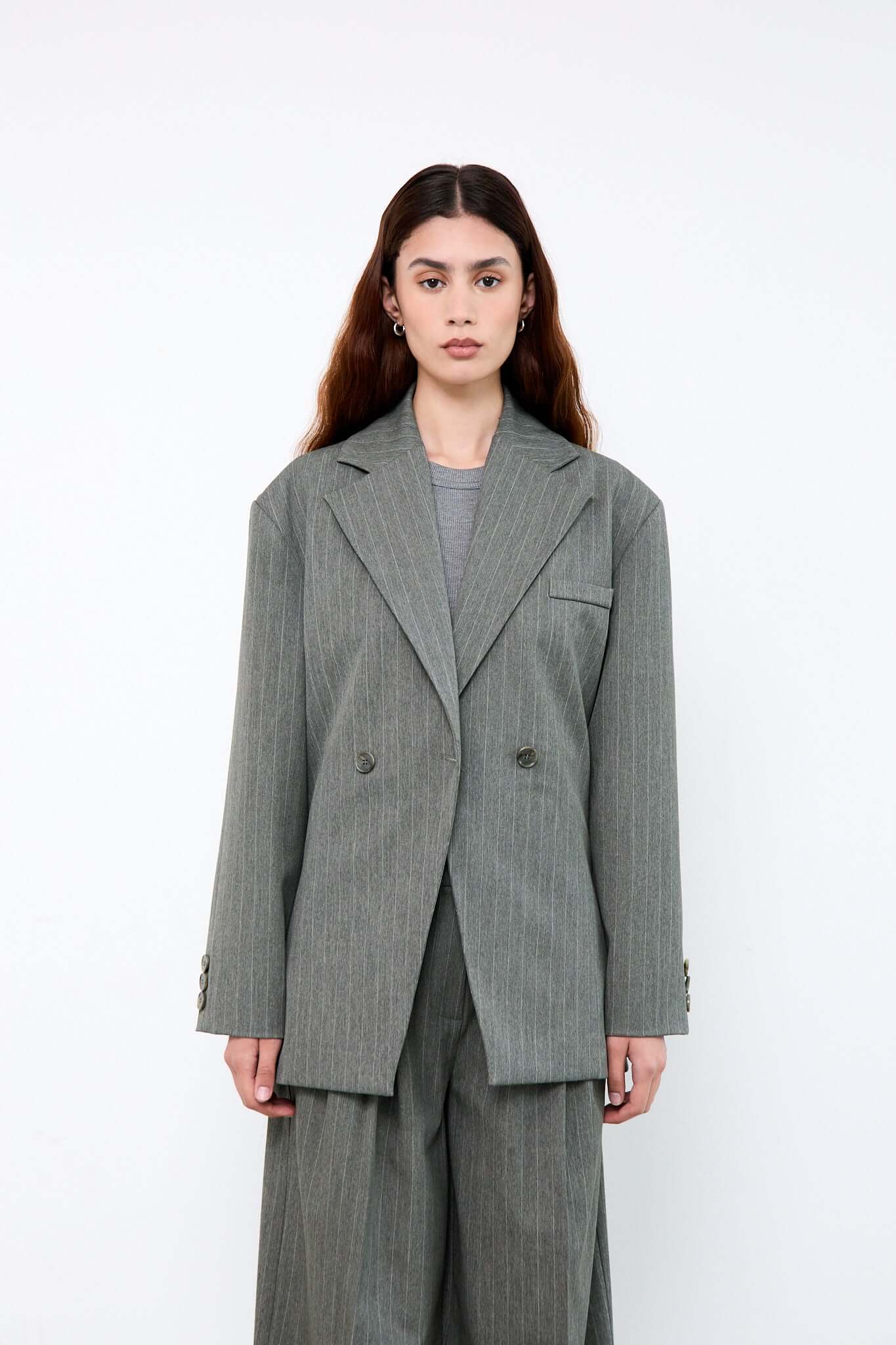 Woman wearing a gray pinstripe suit