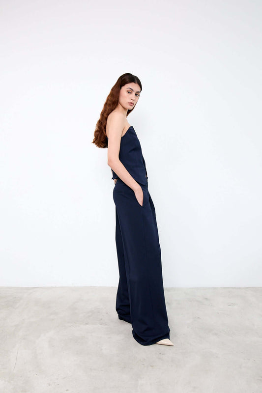 Woman wearing a navy strapless jumpsuit