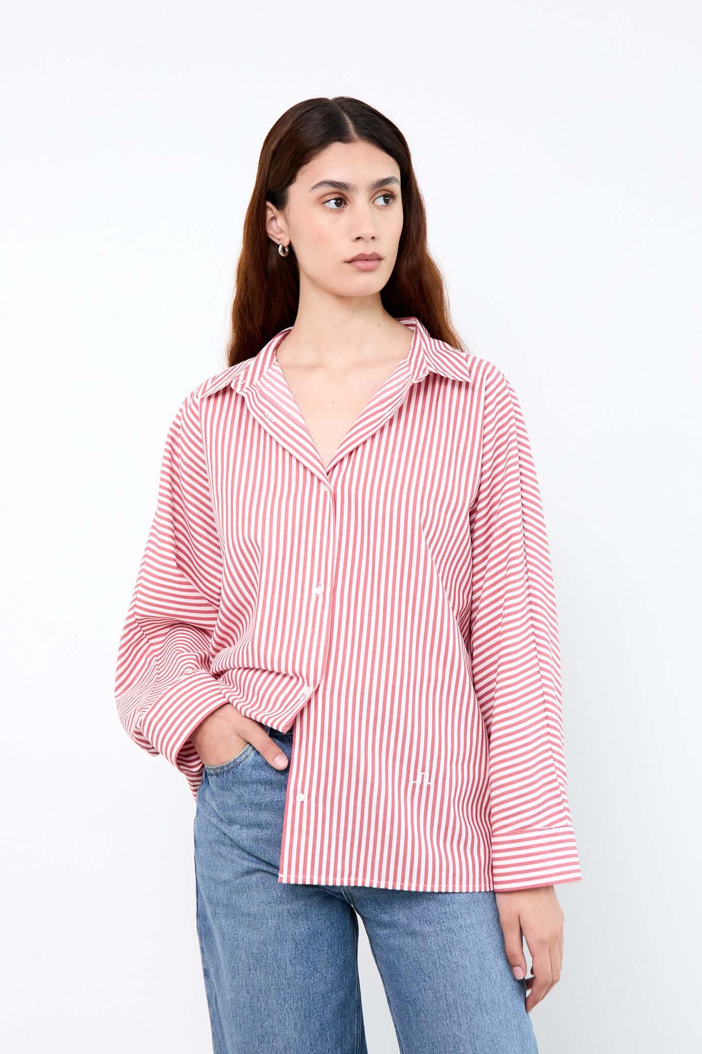 Woman wearing a red and white striped shirt with blue jeans