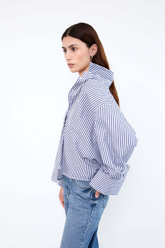 Woman wearing a blue and white striped shirt