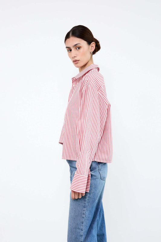 Woman wearing a red and white striped shirt with blue jeans