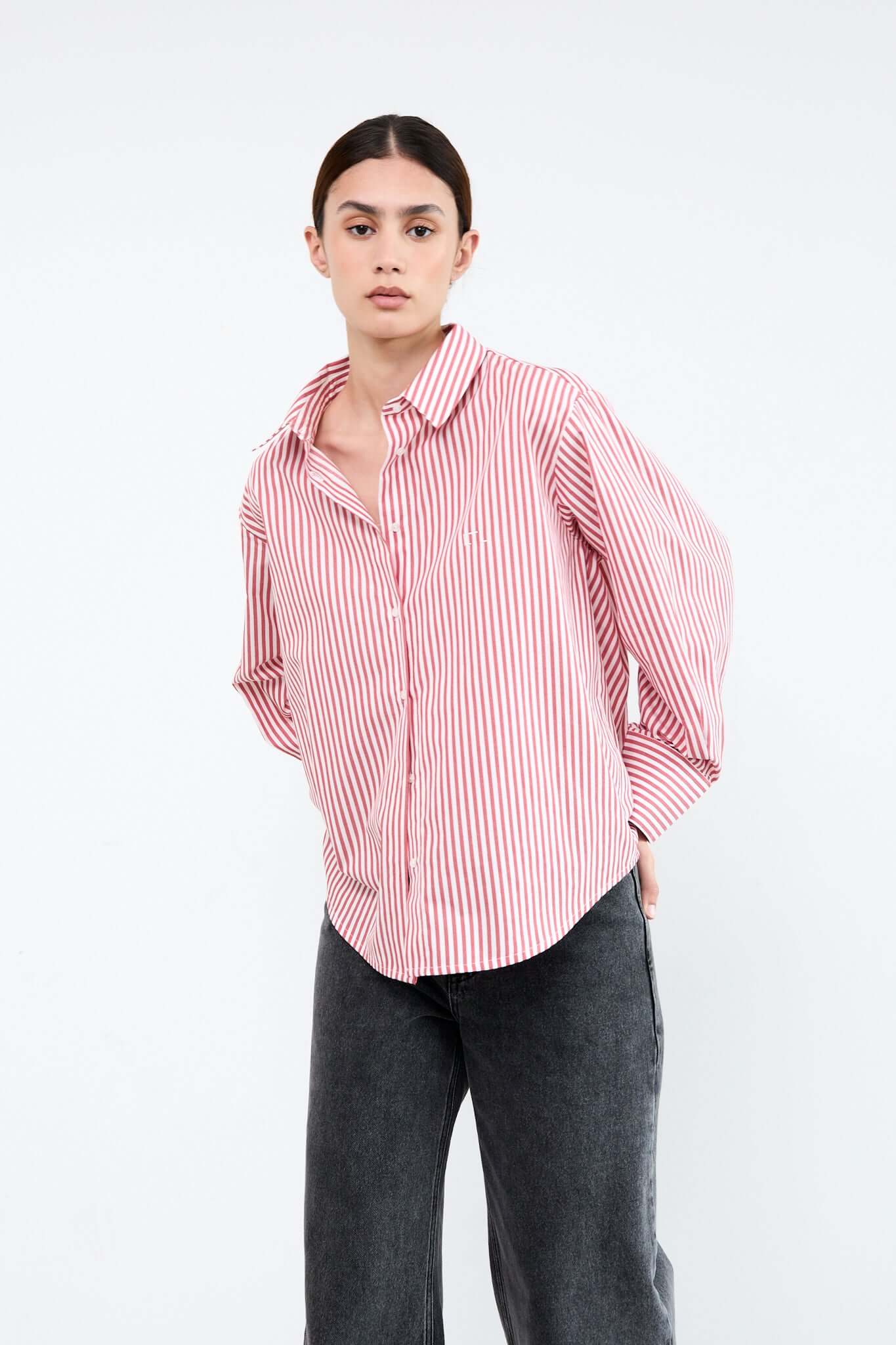 Woman wearing a red and white striped shirt with rolled-up sleeves