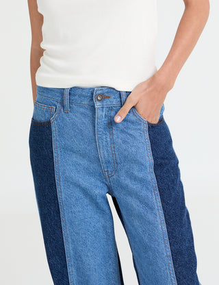 Person wearing blue jeans with a white background
