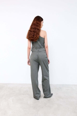 Woman wearing a gray jumpsuit 