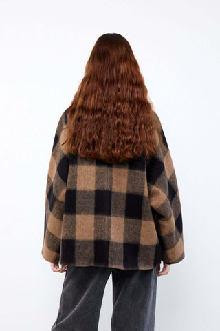 Person wearing a plaid coat