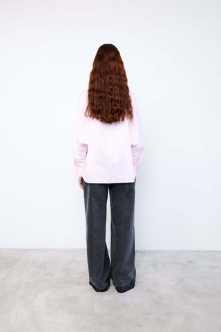 Person wearing a light pink shirt