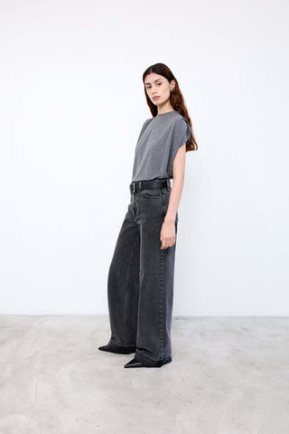 Woman wearing a gray t-shirt and black wide-leg jeans