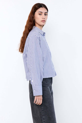 Woman wearing a blue and white striped shirt