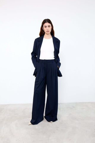 Woman wearing a navy suit with a white shirt