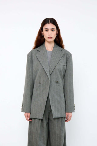 Woman wearing a gray pinstripe suit 