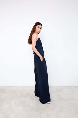 Woman wearing a navy strapless jumpsuit