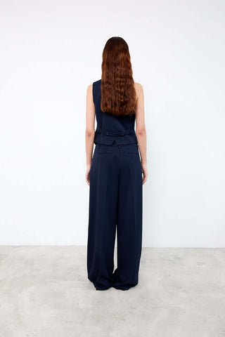 Woman wearing a navy blue jumpsuit 