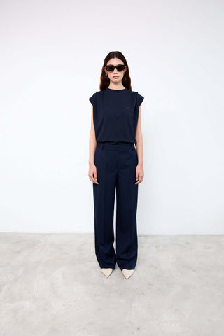 Woman wearing a navy outfit with sunglasses