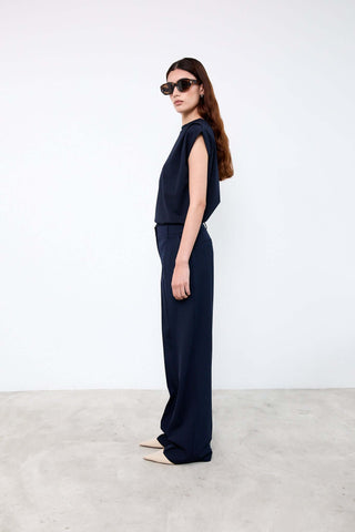 Woman wearing a navy outfit with sunglasses 