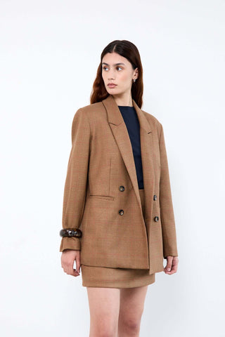 Woman wearing a brown blazer and skirt