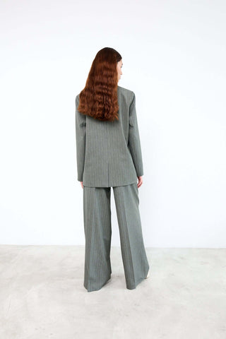 Person wearing a gray suit standing 