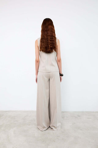 Person wearing a beige jumpsuit 