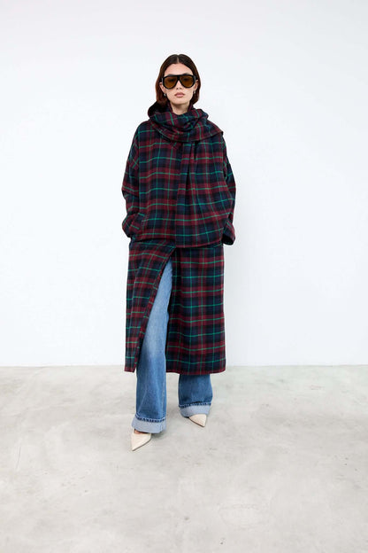 Person wearing a plaid coat and blue jeans 