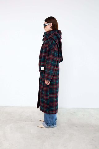 Person wearing a long plaid coat 