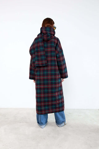 Person wearing a long plaid coat 
