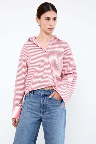 Woman wearing a red and white striped shirt and blue jeans
