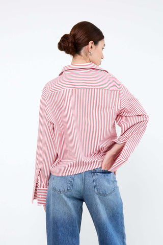 Woman wearing a red and white striped shirt and blue jeans
