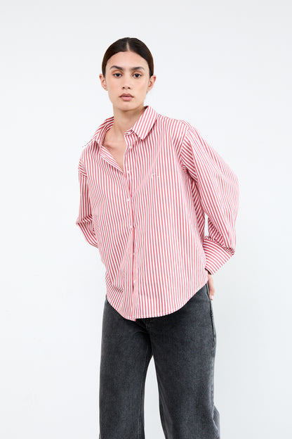 Woman wearing a red and white striped shirt with rolled-up sleeves 