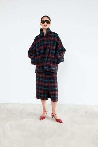 Person wearing a plaid outfit with sunglasses 