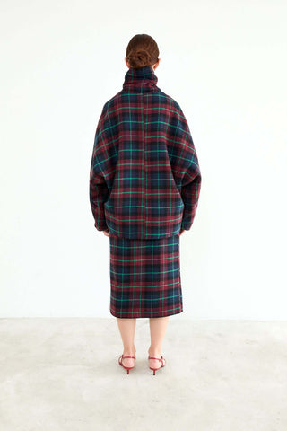 Person wearing a plaid coat and skirt set 