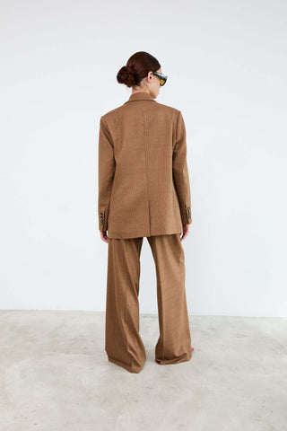 Person wearing a brown suit 