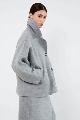 Woman wearing a gray coat