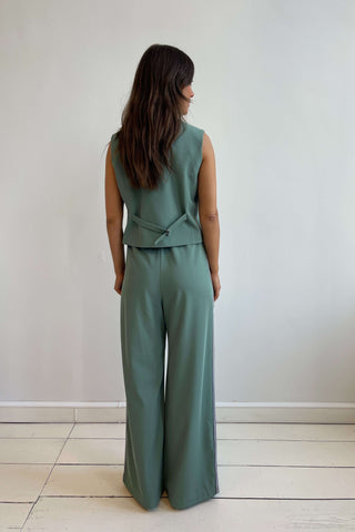 Tailored green vest and wide-leg trousers