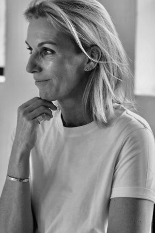 Black and white photo of a woman wearing a white t-shirt.