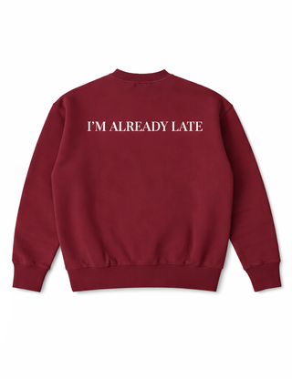 Maroon sweatshirt with 'I'M ALREADY LATE' text on a white background