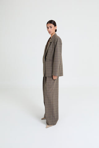 Woman wearing a plaid suit on a white background