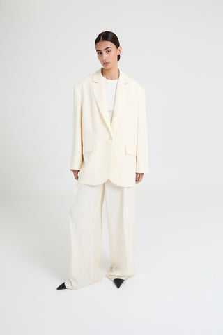 Person wearing a white suit on a white background