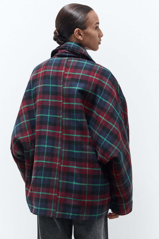 women wearing oversized jacket in red and green checks