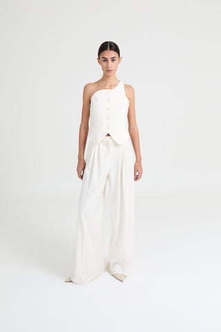 Woman wearing a white one-shoulder dress on a white background