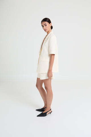 Woman wearing a white outfit on a white background