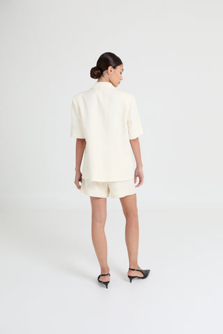 Woman wearing a white outfit on a white background