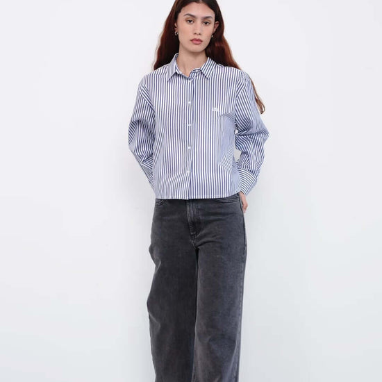 Person wearing a blue and white striped shirt