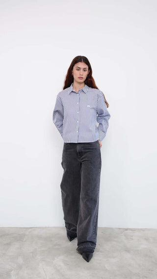 Person wearing a blue and white striped shirt