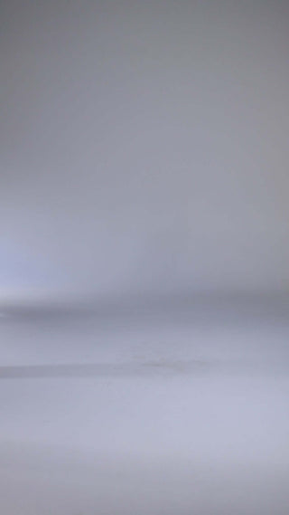 Model wearing white tailored jacket with long slit skirt