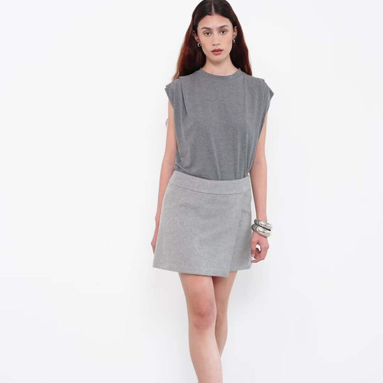 Model wearing grey sleeveless top with matching mini skirt