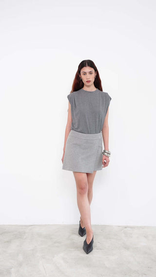 Model wearing grey sleeveless top with matching mini skirt