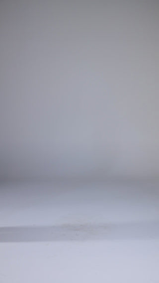 Model wearing white oversized shirt with black wide-leg trousers