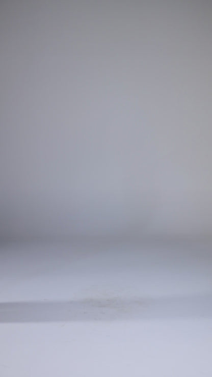 Model wearing white oversized shirt with black wide-leg trousers